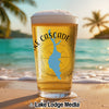 Glass of beer on beach with "Lake Cascade Idaho" text and compass graphic.