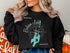 Black sweatshirt with "Balsam Lake Ontario" and compass rose graphic.