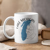 White mug with Lake Michigan map and compass design, emitting steam.