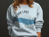 Light blue sweatshirt with "ONEIDA LAKE" and compass design with New York text.