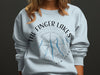 White sweatshirt with "The Finger Lakes New York" text and compass graphic.