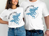 White t-shirts with blue Squam Lake map and compass design, "Squam Lake New Hampshire" text.
