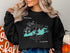 Black sweatshirt with "Key West Florida" and compass graphic.