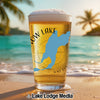 Glass of beer on a beach with "OW LAKE" and a blue lake silhouette.