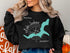 Black sweatshirt with "Beautiful Lake Jackson Georgia" and compass rose map.
