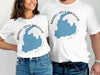 White t-shirts featuring a blue outline map of Merrill Creek Reservoir, New Jersey.