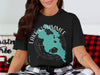 Black t-shirt with teal Lake Kissimmee map, compass, and Florida text.