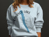 Light blue sweatshirt with a compass graphic and "Owasco Lake New York" text.