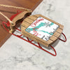 Wooden ornament on red sled with "Merry Christmas from Lake Charlevoix" text.