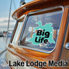 Teal "Big Life" sticker on a boat window, with "Lake Lodge Media" text below.