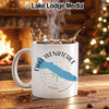 White mug with Lake Wenatchee and Washington design, steaming coffee splashing.