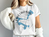 White t-shirt with blue Lake Lahontan map and compass graphic, "Nevada" text.