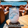 A white insulated tumbler with a custom blue lake map design sits on a wooden boat table.