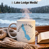 White mug with Keechelus Lake Washington design sits by a window.