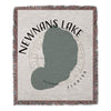Woven blanket featuring a grey outline of Newnans Lake, Florida, with text.