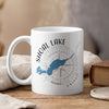 White mug with Shoal Lake Ontario map and compass design.