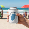 White can koozie with Lake Pulaski Minnesota design held on beach.