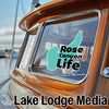 Teal Rose Canyon Life sticker on a wooden boat window, Lake Lodge Media logo.