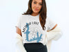 White t-shirt with Medina Lake Texas map and compass graphic.