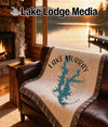 Woven blanket with Lake Murray, Oklahoma design on a leather sofa.