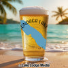 Glass of beer with "Onondaga Lake" text and a blue map overlay on a beach.