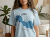 Light blue t-shirt with "Pearl Lake Wisconsin" and compass graphic.