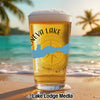 Beer glass with "Geneva Lake" and compass design on a beach