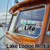 Saguaro Life logo on boat window with "Lake Lodge Media" text.