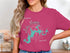 Teal lake map with compass rose and "Lake Monroe, Indiana" text on pink t-shirt.