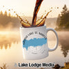 White mug with Grand Lake St. Marys map and compass design, coffee pouring in.