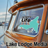 Turquoise map sticker with "gregory Life" text on a boat window.