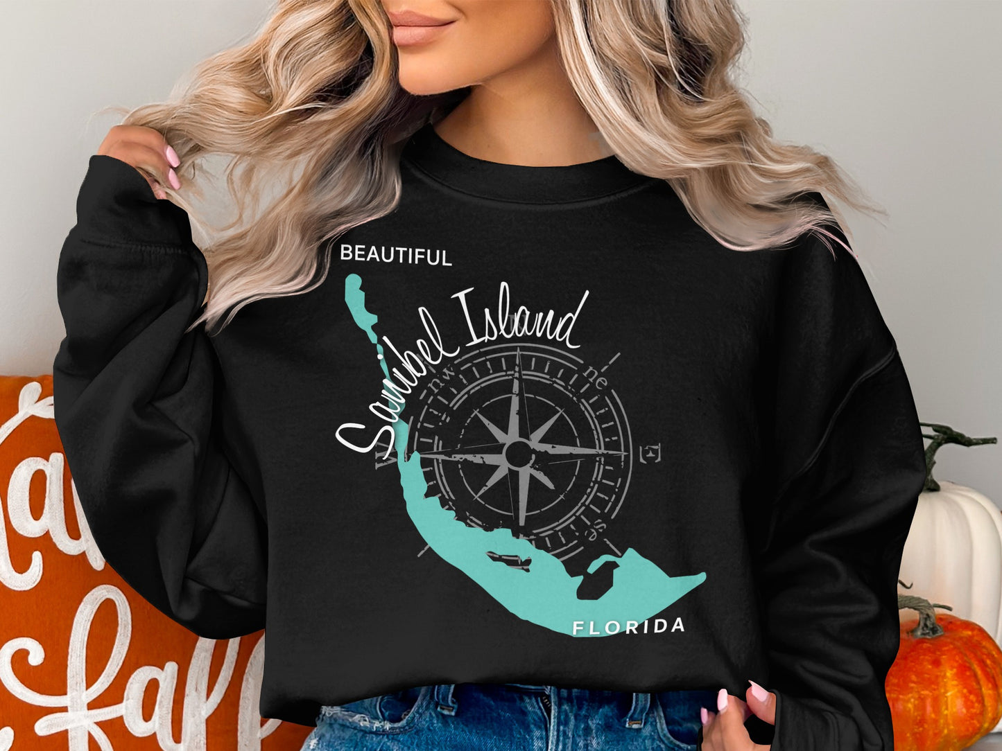 Black crewneck sweatshirt with a teal compass and Sanibel Island, Florida map graphic.
