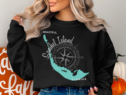 Black crewneck sweatshirt with a teal compass and Sanibel Island, Florida map graphic.