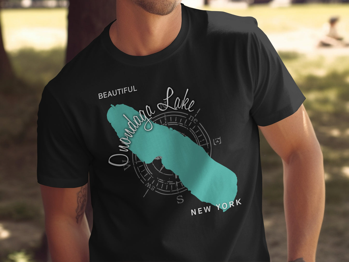 Black t-shirt with a teal outline map of Onondaga Lake and "NEW YORK" text.