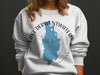 White sweatshirt with blue Lake Derwentwater map and compass graphic.