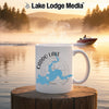 White mug with Caddo Lake map and compass, steaming, on a wooden surface.