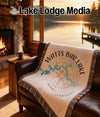 Fringed blanket with Watts Bar Lake map and compass design on a couch.