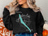 Black sweatshirt with "Beautiful Skaneateles Lake" and compass design.