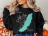 Black sweatshirt with Carlysle Lake Illinois map and compass design.