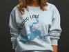 Light blue sweatshirt with Caddo Lake map design and compass graphic.