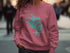 Pink sweatshirt with "Lake Tapps Washington" map graphic and compass rose.
