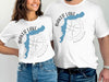 White t-shirts featuring a blue Baker Lake map and compass design with Washington text.
