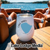 A white insulated wine tumbler with a Lake Mary, Minnesota map sits on a boat table.