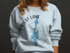 Light blue sweatshirt with Priest Lake Idaho map and compass graphic.