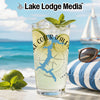 Glass with Lake Coeur d'Alene map and compass, next to limes and sunglasses on a beach.