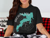 Black t-shirt with teal Arcadia Lake map and compass design, Oklahoma.