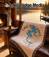 Woven blanket with Lake Blue Ridge Georgia map and compass design on a sofa.