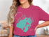 Teal outline map of Indian Lake, Ohio on a pink t-shirt.