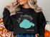 Black sweatshirt featuring "Lake Pontchartrain" map and compass design with "Louisiana."