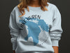Light blue sweatshirt with Lake Huron map graphic and text.